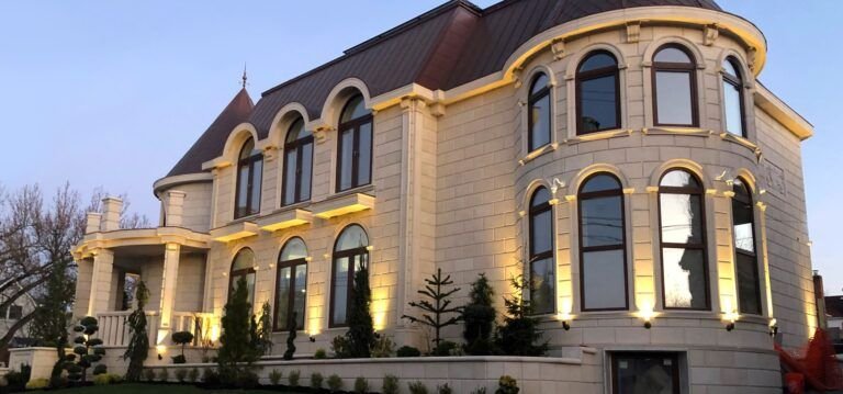 A house featuring architectural precast concrete elements from Coral Cast Architectural Stone. The façade includes decorative window sills, wall panels, and trim that mimic the look of natural limestone or coral stone — showcasing the use of high-quality precast products for residential and commercial buildings.
