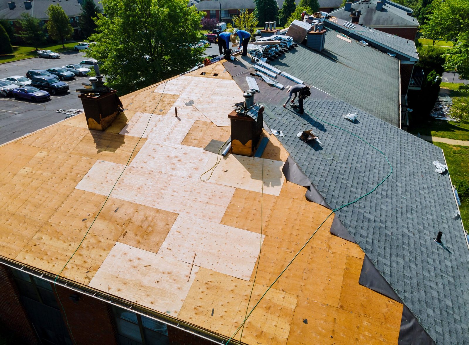 Roof installation in Quebec showing roof replacement work where old shingles are removed to inspect and repair the wooden decking before installing new roofing materials for improved durability and weather protection.