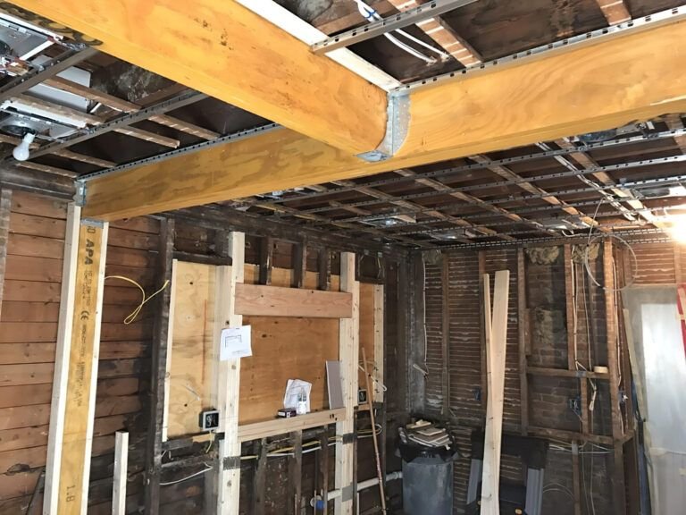 Structural modification services in Quebec shown through an interior renovation project where a new stretch ceiling frame is being installed, featuring metal wall profiles and preparation for ceiling reinforcement.